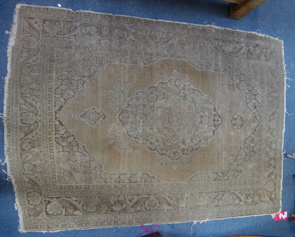 A FADED PERSIAN RUG, 126cm wide x 175cm long (approx)