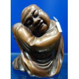 AN ORIENTAL CARVED WOODEN STUDY OF A SEATED MAN, 13.5cm high