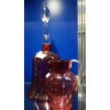A LARGE CRANBERRY GLASS BELL with swirl decoration, 38cm high and a similar jug (2)