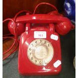 A VINTAGE RED PLASTIC TELEPHONE