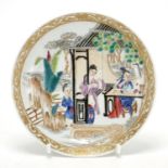 Chinese porcelain shallow dish hand painted in the famille rose palette, with figures in a palace