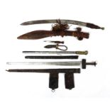 Three Asian and Middle Eastern swords and knifes including a Tuareg, the largest 90cm in length :