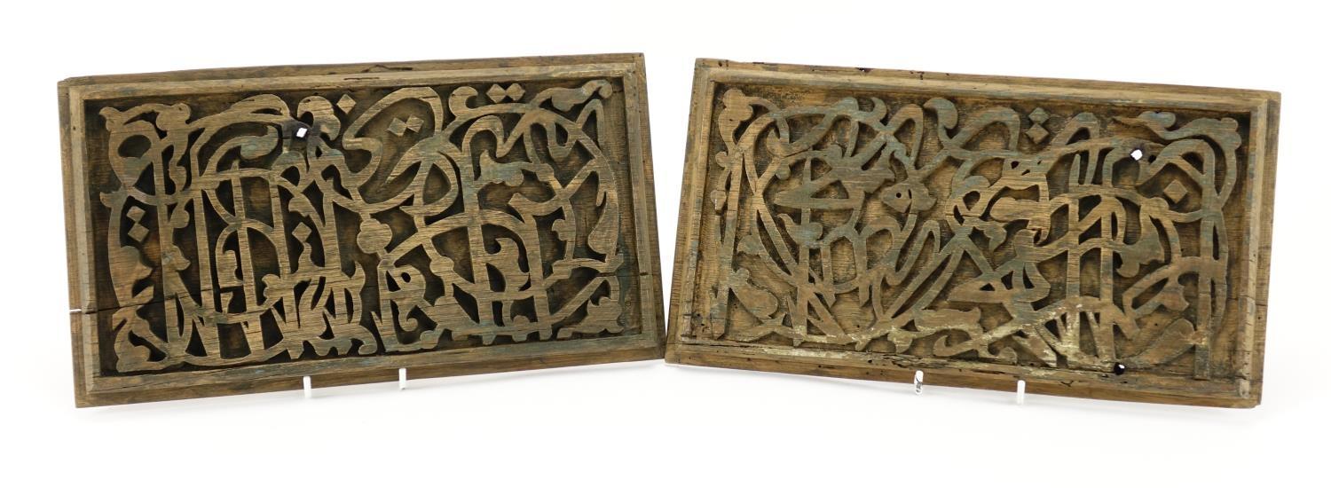 Pair of 15th/16th century Islamic wooden panels carved with script, each 35cm x 19.5cm (