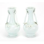 Pair of Chinese celadon glazed vases, each with twin water dragon handles, the bodies incised with