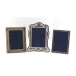 Three rectangular silver easel photo frames, various hallmarks, the largest 26cm x 19cm : For