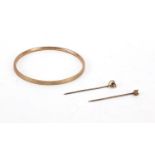 Two Victorian unmarked gold tie pins including a fox head and a 9ct gold metal core bangle, the pins