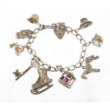 Silver charm bracelet, with a selection of mostly silver charms including top hat, classic car,
