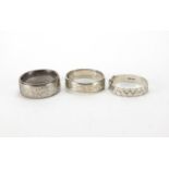 Three silver bangles, two with engraved floral decoration, approximate weight 113.5g : For Extra