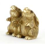 Japanese carved ivory netsuke of a two rabbits, character marks to the base, 3.7cm high : For