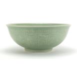 Chinese celadon glazed footed bowl incised with a geometric repeat design, 26.5cm in diameter :