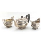 Silver three piece tea service, the sugar bowl and jug with fox head handles, by George Nathan &