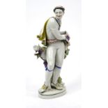 Large 19th century continental hand painted porcelain figure of a grape picker, incised HM27 and