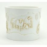Chinese white porcelain brusher pot, finely decorated in relief with horses at play, character marks