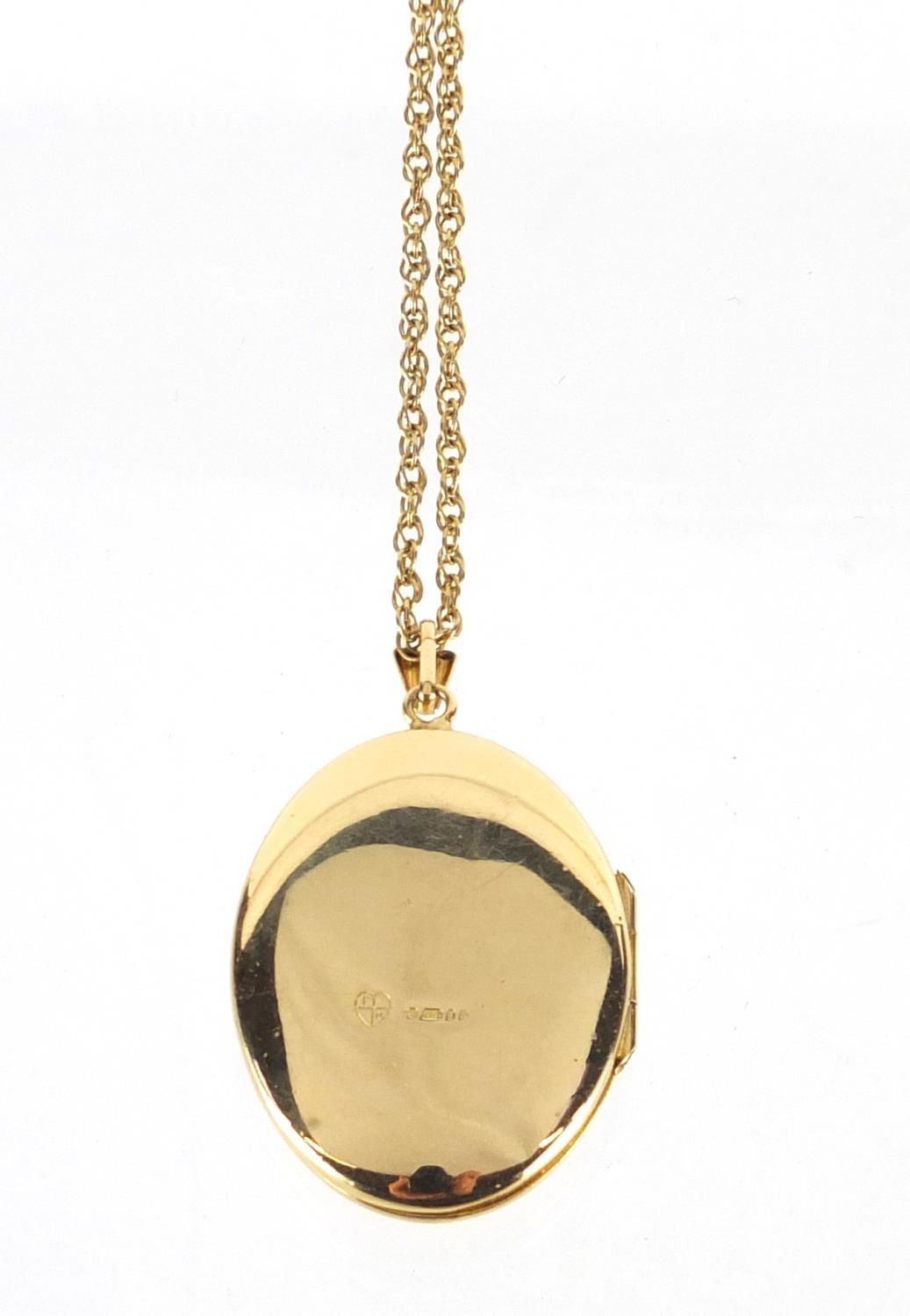 Oval 9ct gold locket set with a garnet on a 9ct gold necklace, the locket 4cm in length, approximate - Image 3 of 4