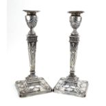 Pair of Adam's style square based candlesticks with tapering columns, embossed with swags and rams