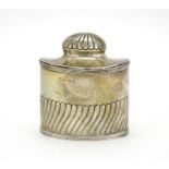 Silver demi fluted tea caddy with fitted spoon to the interior and hinged lid, indistinct makers