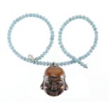 Japanese carved wooden Noh mask, housed on a blue beaded necklace, the mask 4cm high : For Extra