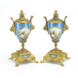 Pair of 19th century Sevres style vase garnitures with twin lions head handles, each hand painted