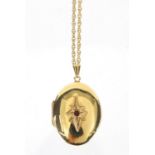 Oval 9ct gold locket set with a garnet on a 9ct gold necklace, the locket 4cm in length, approximate