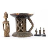 Tribal art comprising a Dogon carved wood figure, three bronze figures raised on a rectangular black