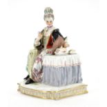 19th century Meissen hand painted porcelain figurine of a female seated at a dressing table, blue