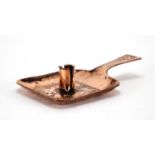 Arts & Crafts Newlyn school copper chamber stick, embossed with two stylised fish, 22cm in