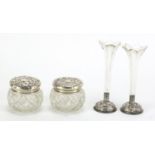 Pair of cut glass bud vases and jars with covers, both with silver mounts, the largest 12.5cm high :