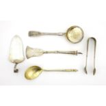Russian silver flatware including a sifting spoon, cake server and a pair of white metal sugar