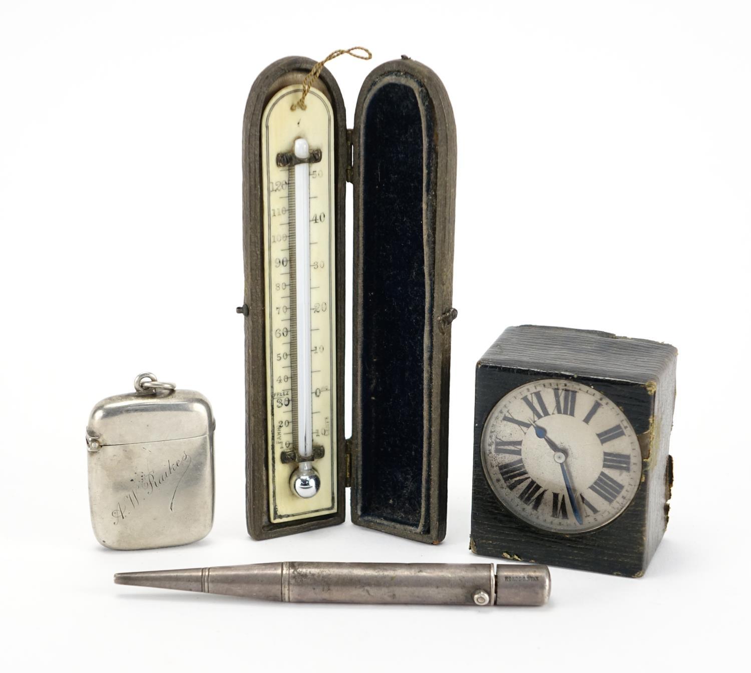 Miscellaneous objects comprising a silver vesta, Parker's pointer pencil, leather cased travel clock