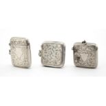 Three rectangular silver vesta's with engraved floral decoration, Birmingham hallmarks, the