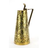 Arts & Crafts brass jug by Keswick, the tapering body embossed with stylised flowers and foliage,