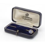 Unmarked gold cabochon star sapphire tie pin, housed in a J W Benson London tooled leather box, 6.