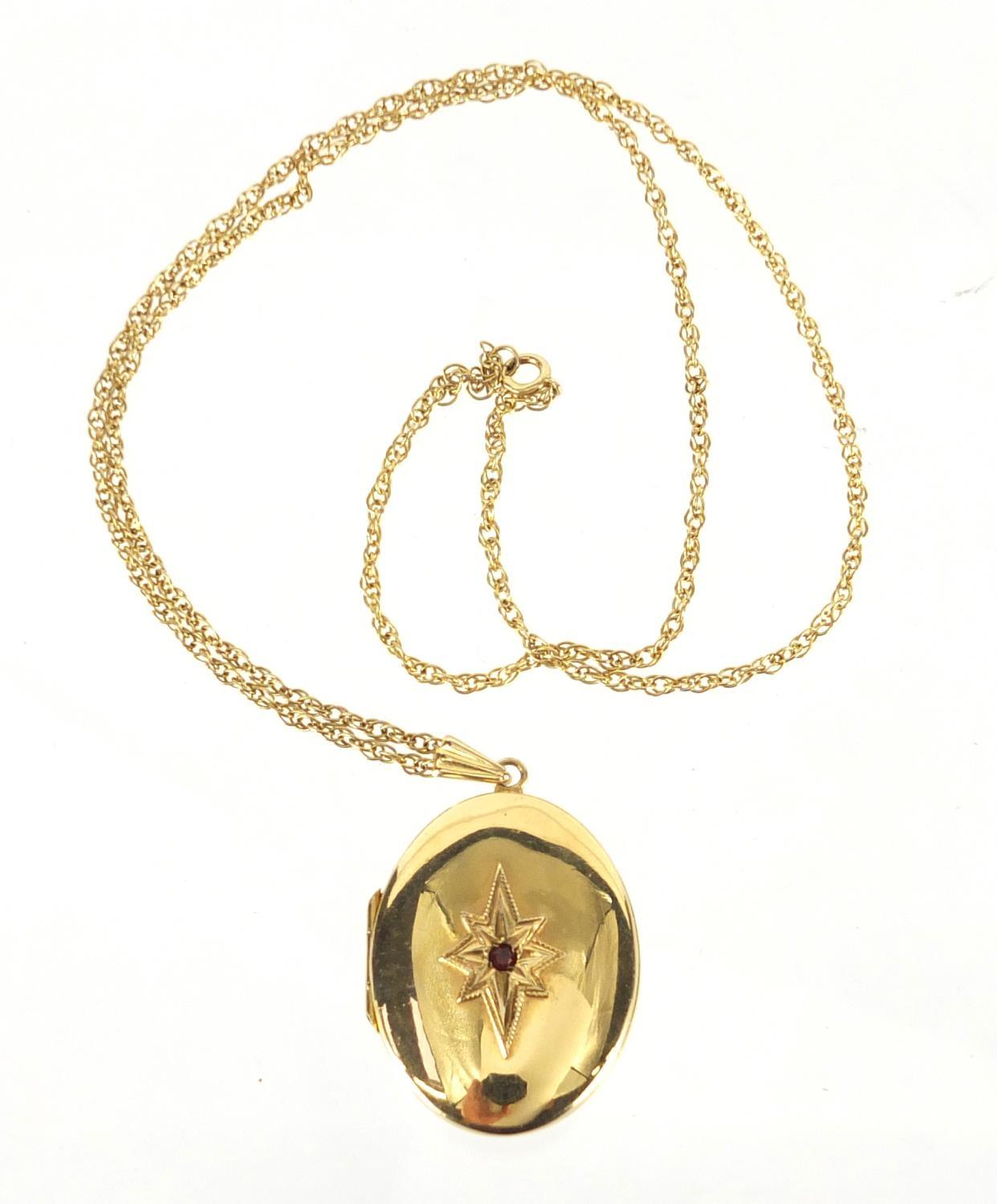 Oval 9ct gold locket set with a garnet on a 9ct gold necklace, the locket 4cm in length, approximate - Image 2 of 4