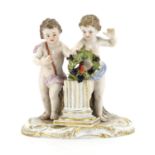 19th century Meissen hand painted porcelain figure group of two putti holding a wreath with a