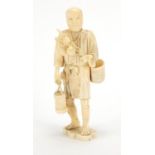 Japanese carved ivory okimono of a man carrying fruit, character marks to the base, 23cm high :