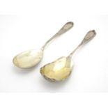 Two Russian silver serving spoons, one with stylised flowers, both marked 84, the largest 23.5cm
