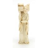 Japanese carved ivory okimono of an elder holding a box, character marks to the base, 12.5cm