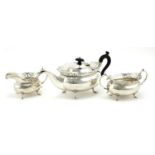 Silver three piece tea service with pierced rims, by A E Poston & Co Ltd, the teapot 31cm wide,