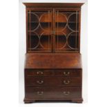 Georgian mahogany bureau bookcase by Warings, fitted with a pair of glazed doors above a fall with