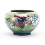 Moorcroft pottery footed bowl, hand painted and tube lined in the Orchid pattern, impressed and