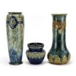 Two Art Nouveau Royal Doulton vases and a Doulton Lambeth tobacco jar decorated in relief with