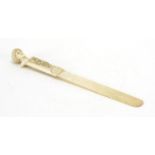 19th century ivory page turner, the handle finely carved with a classical bust and flowers, 26cm
