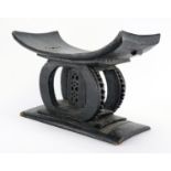 Tribal interest carved hardwood head rest, 34cm high x 49cm wide : For Extra Condition Reports