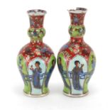 Pair of Chinese porcelain vases, hand painted with panels of figures and flowers, Kangxi leaf mark