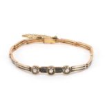 Art Deco two tone unmarked gold diamond bracelet, 16cm in length, approximate weight 11.2g : For