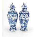 Pair of Chinese blue and white baluster vases and covers, each hand painted with figures and