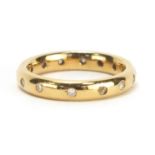 18ct gold diamond eternity ring, retailed by Garrard, housed in a tooled leather box, size J,