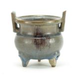 Chinese pottery tripod censer with twin handles, having a turquoise and purple glaze, 12.5cm