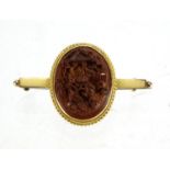 Chinese unmarked gold bar brooch, carved with figures before a building, 3.5cm in length,