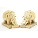 Pair of carved ivory elephants raised on rectangular elephant teeth bases, each 13cm wide : For